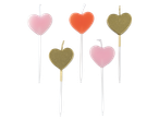 Pink, orange, and gold heart-shaped candles.