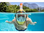 Woman wearing a CRIVIT Premium Snorkel Mask underwater in a pool.