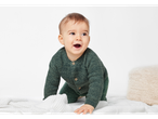 Lupilu® Baby Cardigan in green on a crawling baby.