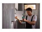 Man using a cordless work light to inspect an electrical panel.