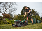 Man mowing lawn with a Parkside lawnmower.