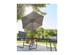 Outdoor dining set with a grey parasol, table, and chairs on a patio.