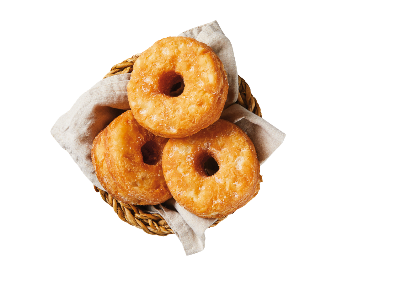 Drie gesuikerde donuts in een mandje.