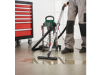 PARKSIDE® 1400W Wet & Dry Vacuum Cleaner cleaning a puddle on a workshop floor.