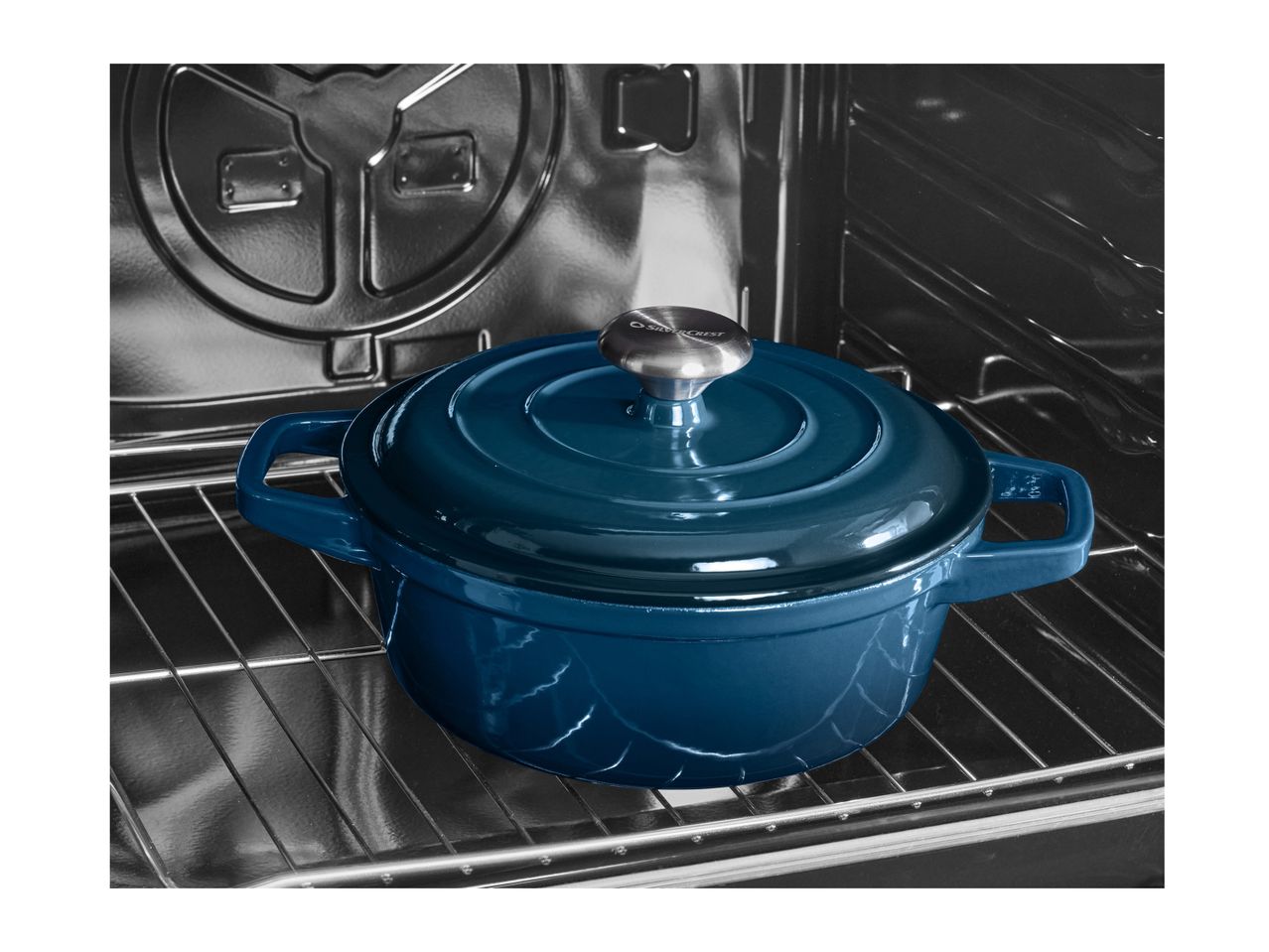 A blue cast iron Dutch oven with a lid, placed on a rack inside an oven.