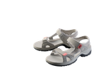 Pair of light grey women's sports sandals with pink accents on a black background.