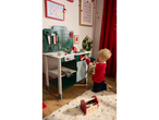 A child plays with a Lupilu wooden toy workbench, featuring various tools and accessories.