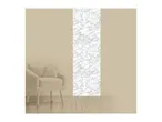 Beige armchair with a cushion next to a wall with a vertical marble pattern.