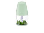 A SilverCrest mini food chopper with chopped parsley inside.