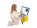 Child playing with a wooden easel, writing on the whiteboard with a clock and magnetic letters.