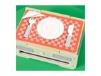 Wooden toy toaster with a plate, fork, knife, and napkin on a red checkered surface.