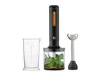 Black immersion blender with wooden buttons, a measuring cup, and a chopper attachment with herbs.