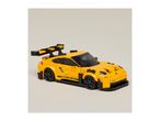 A yellow toy sports car with a large rear spoiler and black accents.