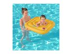Woman holding a baby in a yellow inflatable baby float in a swimming pool.