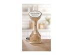 Handheld garment steamer with a transparent water tank and a brush attachment on a wooden surface.