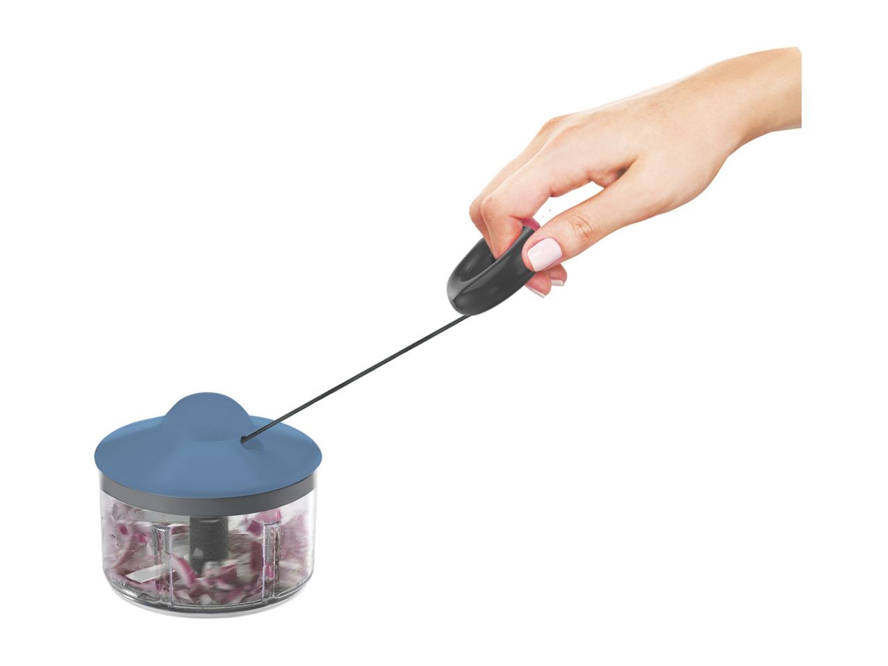 Hand pulling the cord of a manual food chopper filled with chopped red onions