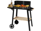 Black barbecue grill with various meats and vegetables cooking, and spices on a side shelf.