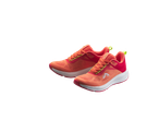 Pair of vibrant coral and red running shoes with neon yellow accents on a black background.