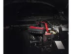 Ultimate Speed jump starter and cables in an engine bay.