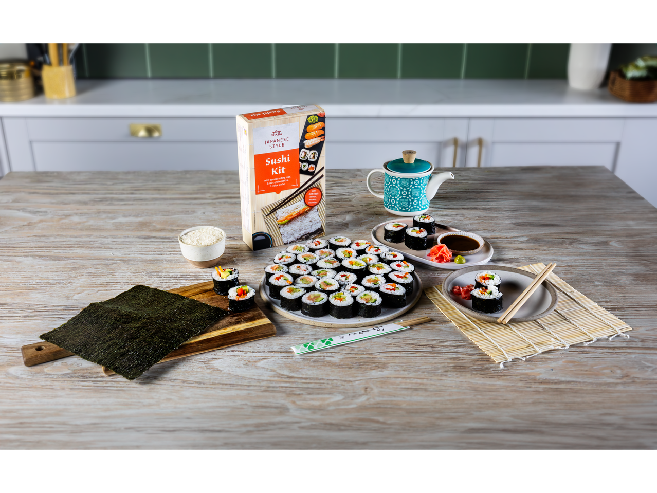 Vitasia Sushi Kit with prepared sushi rolls and ingredients on a wooden table.