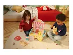 Two children playing with a wooden toy candy shop cart, featuring various sweets and treats.
