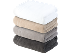 Stack of towels: white, beige, grey and dark grey.