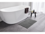LIVARNO home gray bath mat on a tiled floor next to a white bathtub.