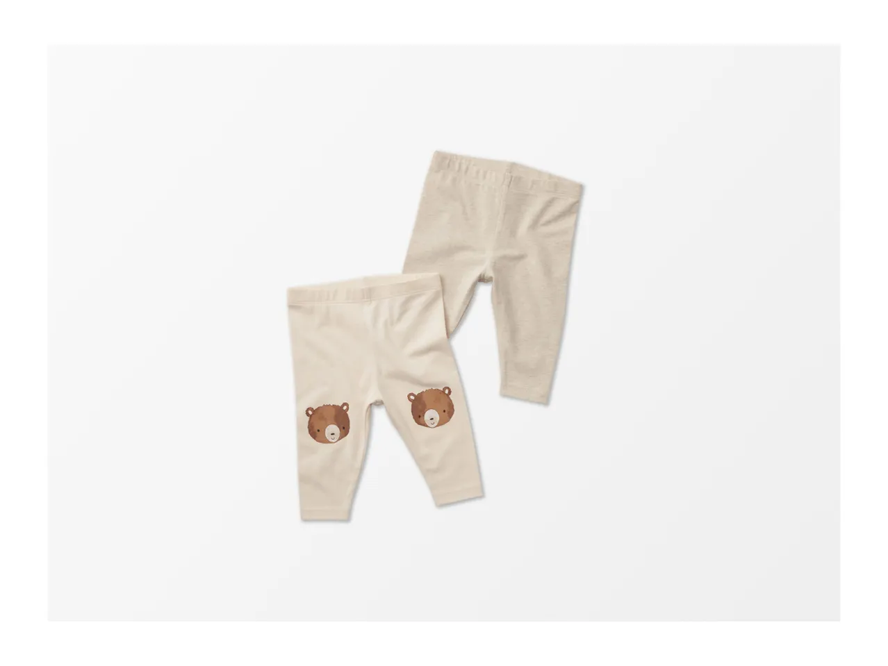 Two pairs of baby leggings, one with bear faces on the knees.