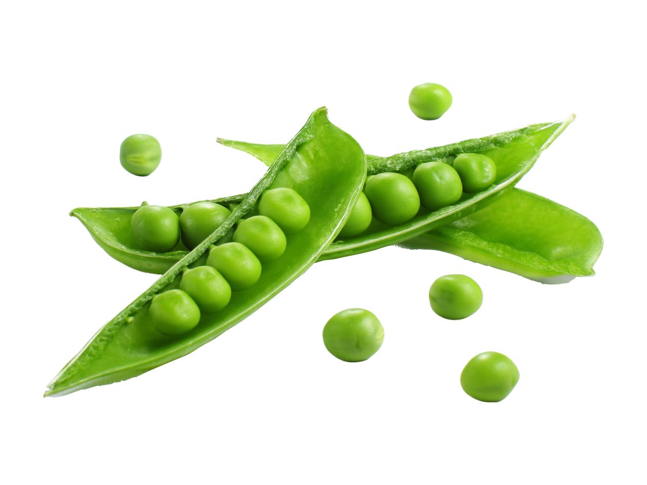Two open pea pods with loose green peas scattered around.