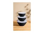 Stack of three black mixing bowls with clear lids on a wooden surface.