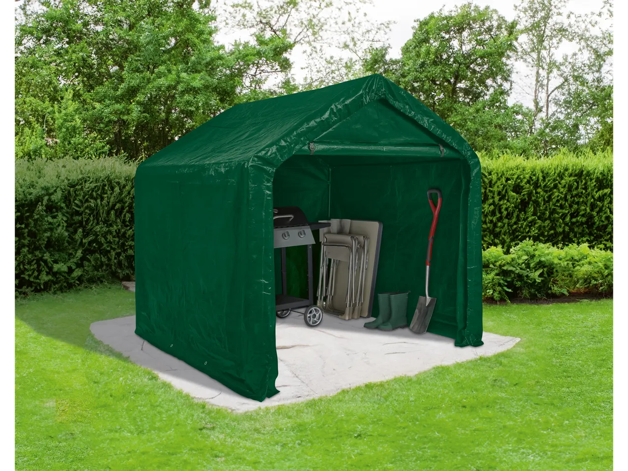 Green tent garage with a grill, folding chairs, boots, and a shovel on a garden patio.