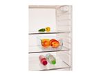 Open refrigerator with apples, bananas, peppers, and bottled drinks on shelves.