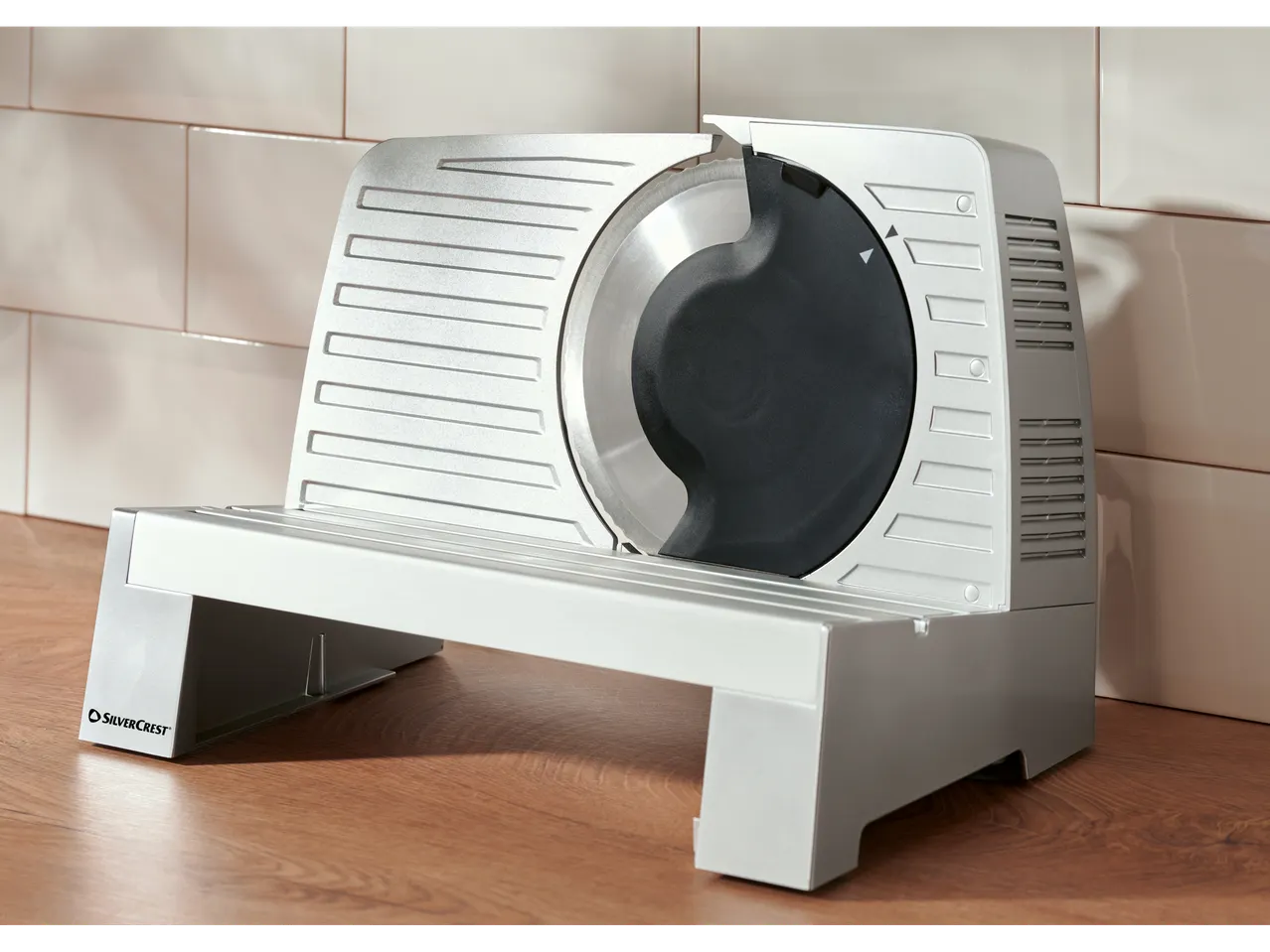 SILVERCREST® Electric Multi-Purpose Slicer on a wooden surface with tiled background.