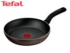 Brown frying pan with a black handle and a red heat indicator in the center.