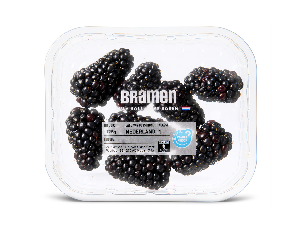 Een doorzichtige plastic bak met bramen, met productinformatie en een 'Planet Proof' label.