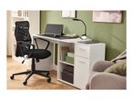 Black mesh office chair and white desk with a monitor, lamp, and storage shelves.