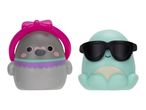 Two squishy toys: a grey bird with a pink bow headband and a teal octopus with sunglasses.