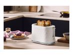 A white textured two-slice toaster with toasted bread on a kitchen counter.
