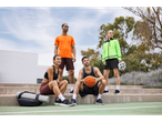 Four people in Crivit sportswear pose on a basketball court.