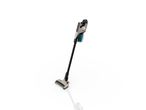 A beige and black cordless stick vacuum cleaner stands on a white surface.