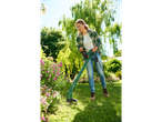Woman using a Parkside grass trimmer in a garden.