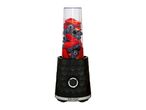 Black personal blender filled with fresh strawberries and blueberries