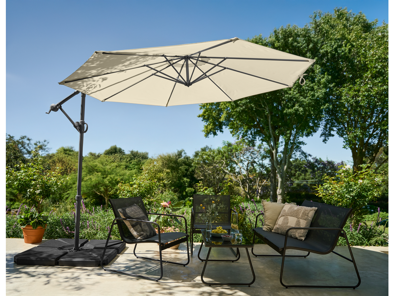 Livarno Cantilever Parasol with outdoor seating area on a patio.