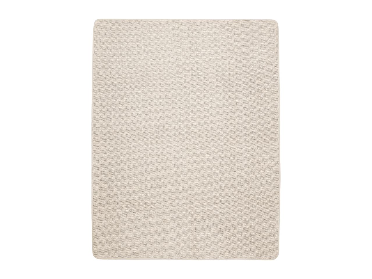A rectangular beige bath mat with a textured surface and rounded corners.