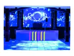 DJ booth with a light-up dance floor and large screens displaying blue light patterns.