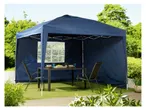 A navy blue pop-up gazebo with side panels provides shade for an outdoor patio table and chairs.