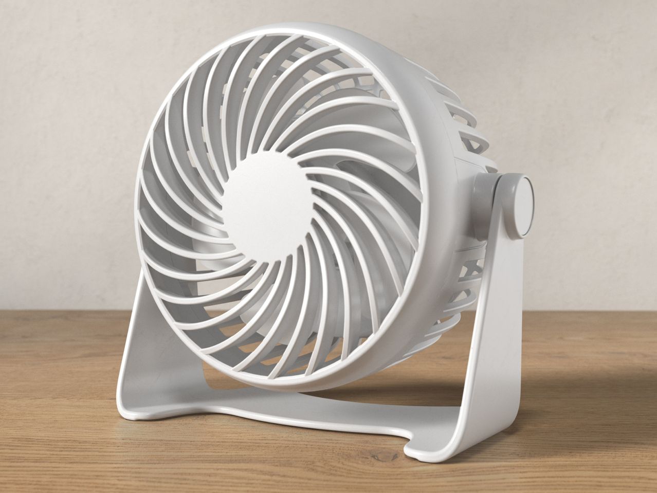 A white portable fan with a spiral grill sits on a wooden surface.