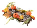 Autumnal candle holder with pumpkins, leaves, and berries on a wooden base.