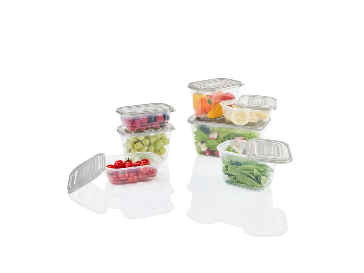 Clear food storage containers filled with fresh fruits and vegetables.