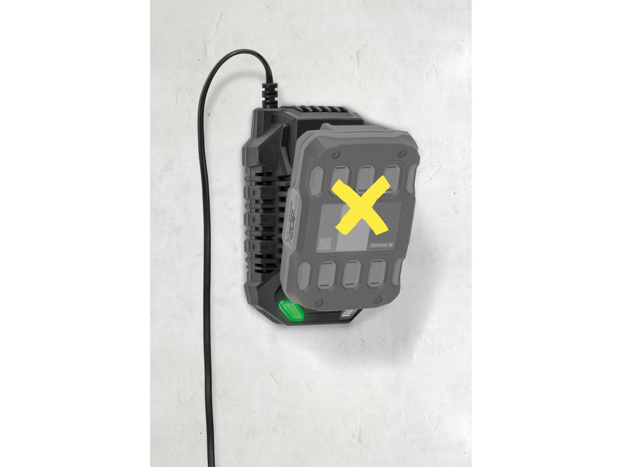 A power tool battery charger with a battery inserted, mounted on a white wall.